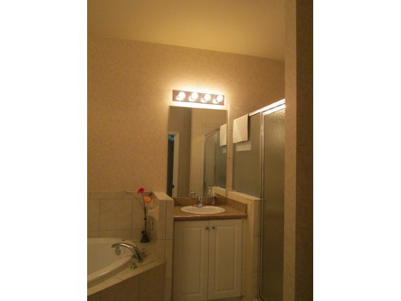 7920 Mahogany Run Lane, Unit 1024 Naples, FL 34113 - Photo 12 of 18 a bathroom with a sink and mirror