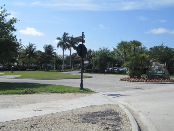 7920 Mahogany Run Lane, Unit 1024 Naples, FL 34113 - Photo 3 of 18 a street view with a yard