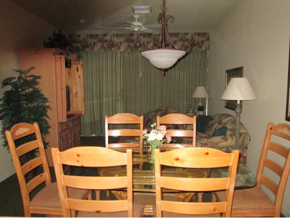 7920 Mahogany Run Lane, Unit 1024 Naples, FL 34113 - Photo 7 of 18 a view of a dining room with furniture and wooden floor