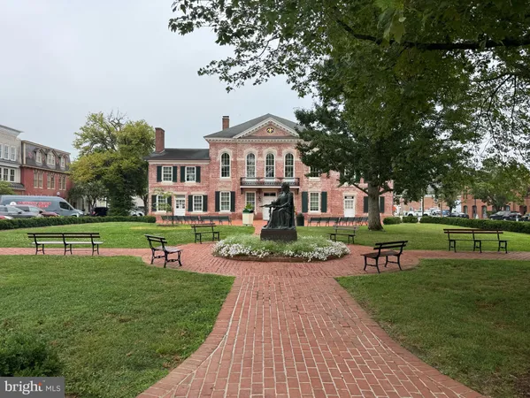 a front view of a house with a yard table and chairs