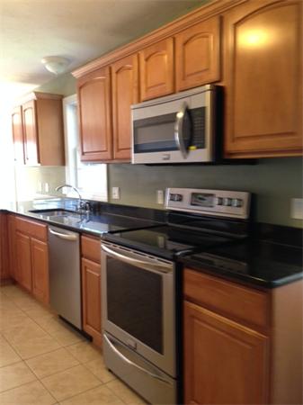 13 Wrentham Road Worcester, MA 01602 - Photo 18 of 18 a kitchen with stainless steel appliances granite countertop a stove microwave and sink