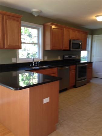 13 Wrentham Road Worcester, MA 01602 - Photo 3 of 18 a kitchen with stainless steel appliances granite countertop a sink a stove and a microwave