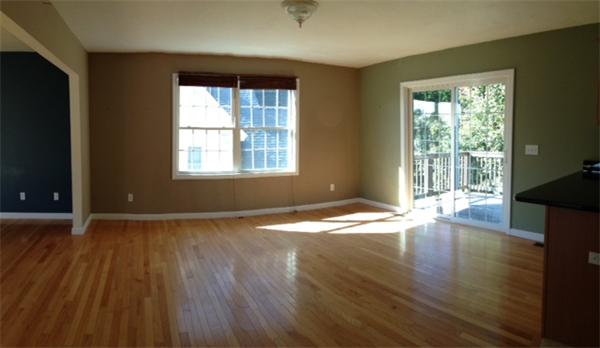 13 Wrentham Road Worcester, MA 01602 - Photo 4 of 18 a view of an empty room with wooden floor and a window