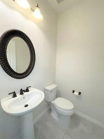 a kitchen with granite countertop white cabinets and a stove top oven