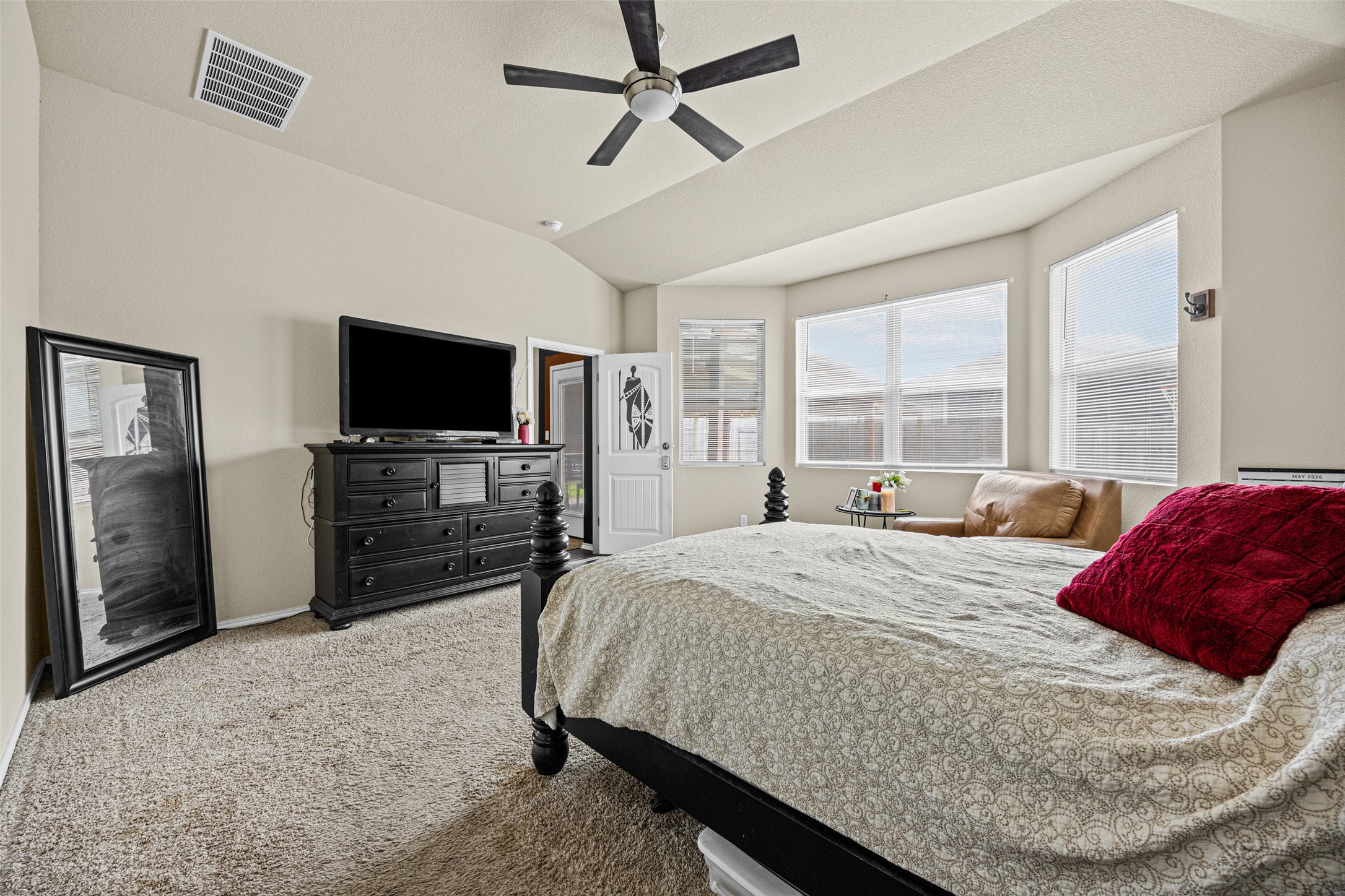 19113 Rookery Trail Pflugerville, TX 78660 - Photo 22 of 36 Spacious room featuring vaulted ceilings, a ceiling fan with integrated lighting, and light-colored wall-to-wall carpeting