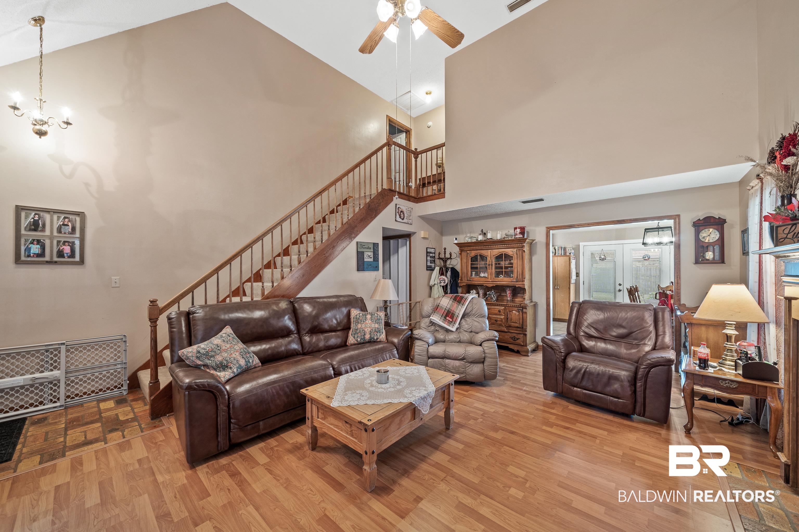 460 Ridgewood Drive Daphne, AL 36526 - Photo 2 of 31 Living room with high vaulted ceiling, ceiling fan with notable chandelier, and light hardwood / wood-style flooring