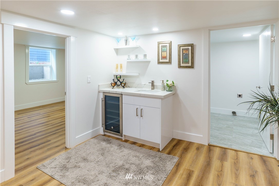 1129 North 84th Street Seattle, WA 98103 - Photo 19 of 24 a view of a kitchen with wooden floor and a sink