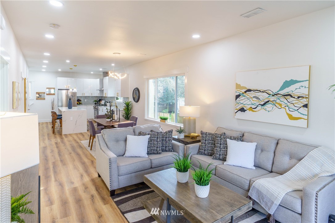 1129 North 84th Street Seattle, WA 98103 - Photo 2 of 24 a living room with furniture and a large window