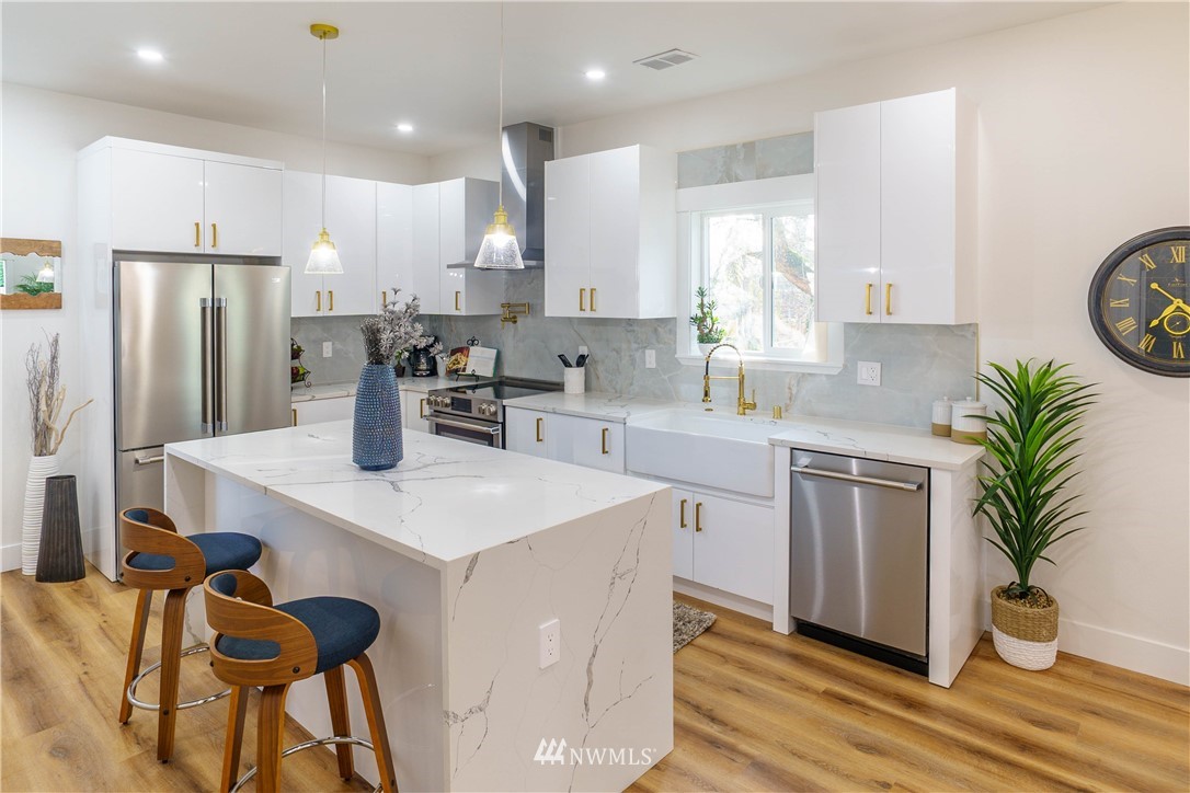 1129 North 84th Street Seattle, WA 98103 - Photo 5 of 24 a kitchen with a sink a refrigerator and a stove