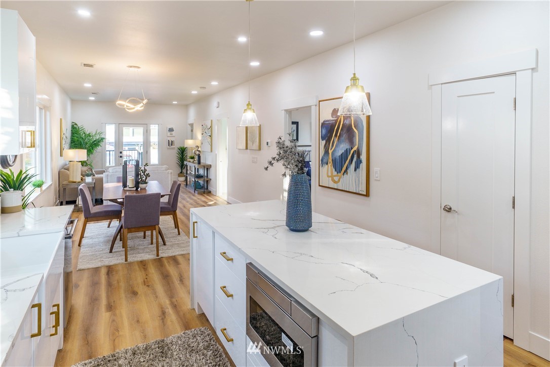 1129 North 84th Street Seattle, WA 98103 - Photo 8 of 24 a view of a kitchen and dining area with chandelier