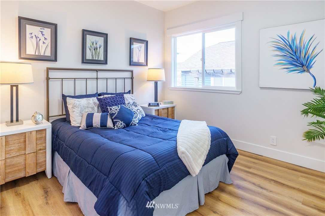 1129 North 84th Street Seattle, WA 98103 - Photo 9 of 24 a bed sitting in a bedroom next to a window