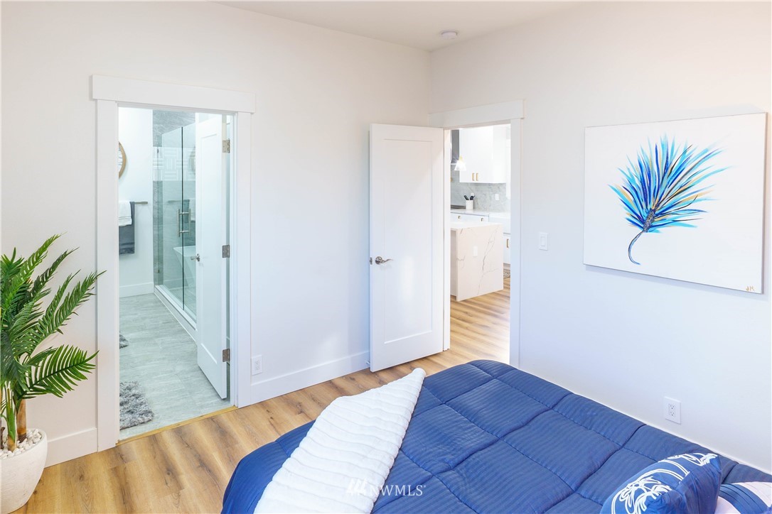 1129 North 84th Street Seattle, WA 98103 - Photo 10 of 24 a bedroom with a bed and a potted plant