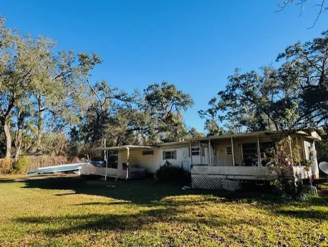 a front view of a house with a garden and trees