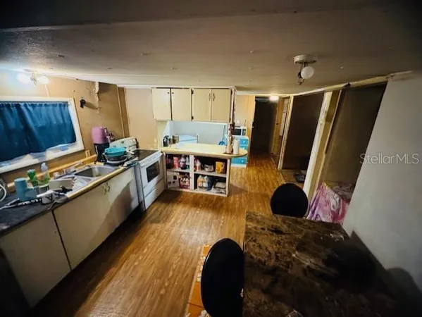a kitchen with stainless steel appliances kitchen island granite countertop a sink dishwasher stove and cabinets