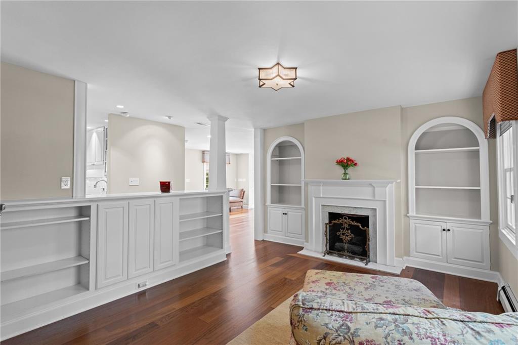 73 Stonedale Road Sewickley, PA 15143 - Photo 22 of 50 a view of a livingroom with a fireplace a chandelier and wooden floor