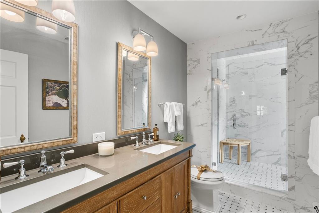 73 Stonedale Road Sewickley, PA 15143 - Photo 33 of 50 a bathroom with a granite countertop sink toilet a mirror a vanity and shower