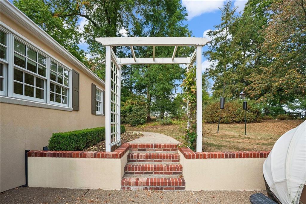 73 Stonedale Road Sewickley, PA 15143 - Photo 41 of 50 a view of a white house with a small yard and large windows
