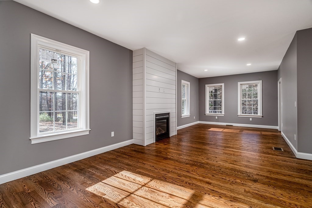 117 Center Road Shirley, MA 01464 - Photo 11 of 42 a view of empty room with wooden floor and fireplace