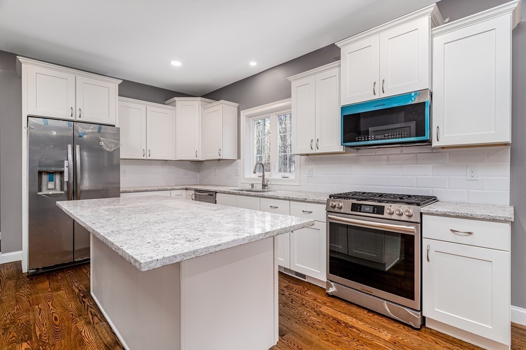 117 Center Road Shirley, MA 01464 - Photo 13 of 42 a kitchen with stainless steel appliances granite countertop a sink stove and microwave