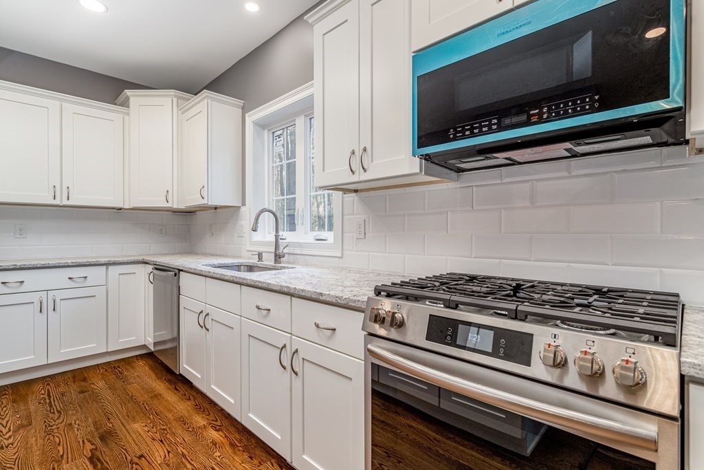 117 Center Road Shirley, MA 01464 - Photo 14 of 42 a kitchen with stainless steel appliances a stove a microwave and cabinets