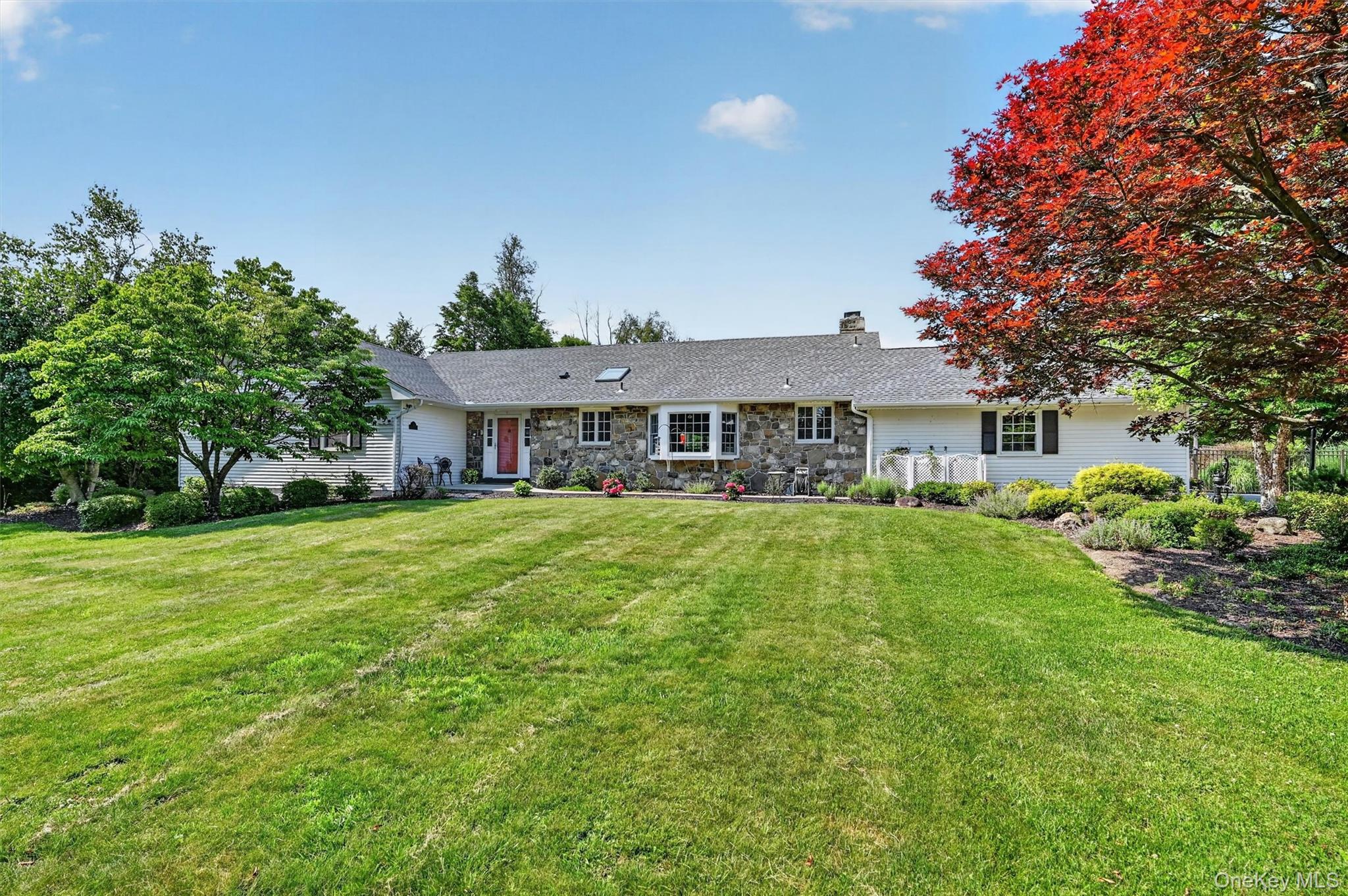5 Hedges Road Warwick, NY 10990 - Photo 3 of 48 Classic stone and vinyl siding, mature landscaping, and a wide front lawn create a welcoming first impression at this 4 bedroom, 2.5 bath ranch in Warwick, NY.