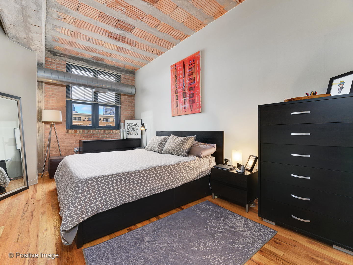 Undisclosed Address Chicago, IL 60616 - Photo 11 of 18 a bedroom with a bed and a dresser