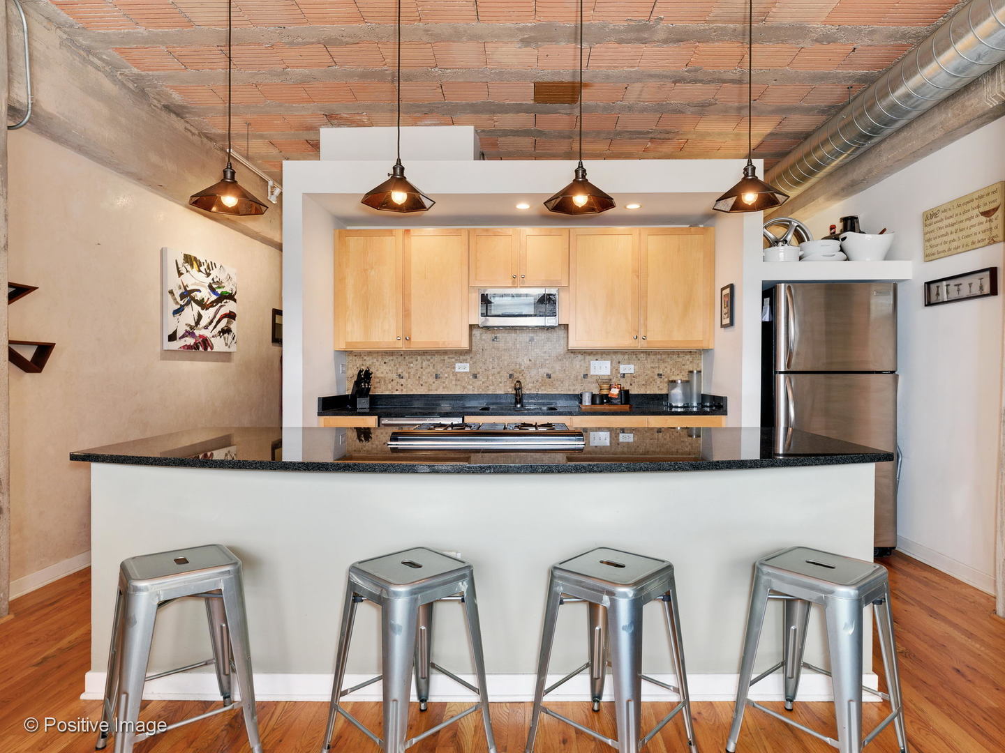 Undisclosed Address Chicago, IL 60616 - Photo 3 of 18 a kitchen with stainless steel appliances granite countertop a table chairs in it and wooden floors