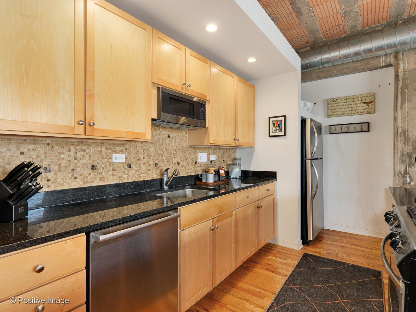Undisclosed Address Chicago, IL 60616 - Photo 6 of 18 a kitchen with stainless steel appliances granite countertop a sink stove and refrigerator