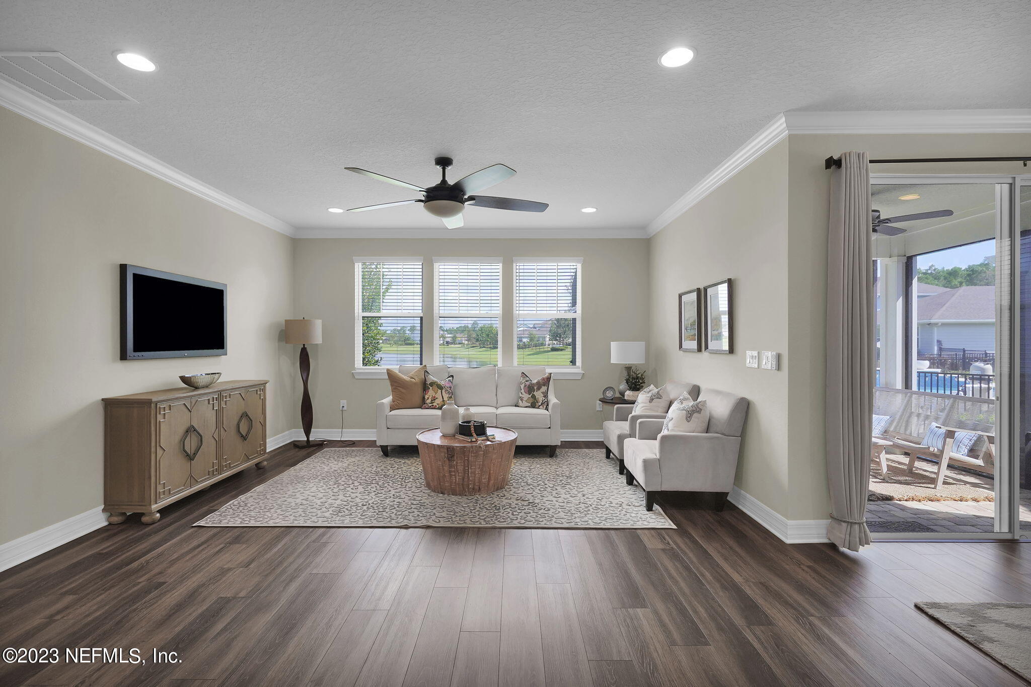 39 Lakefront Lane St. Augustine, FL 32095 - Photo 12 of 66 a living room with furniture wooden floor and a flat screen tv