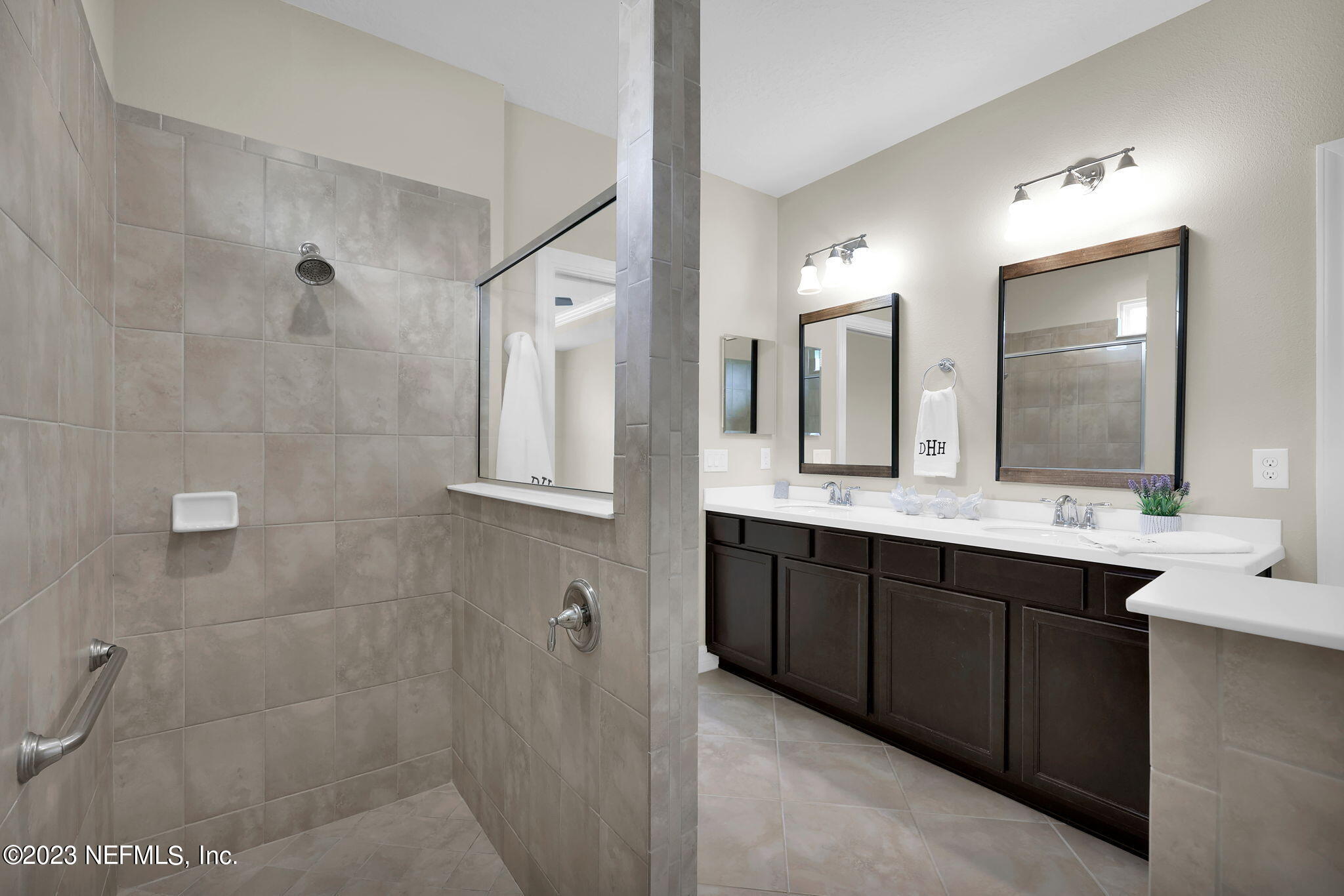 39 Lakefront Lane St. Augustine, FL 32095 - Photo 21 of 66 a bathroom with a double vanity sink a mirror and a shower