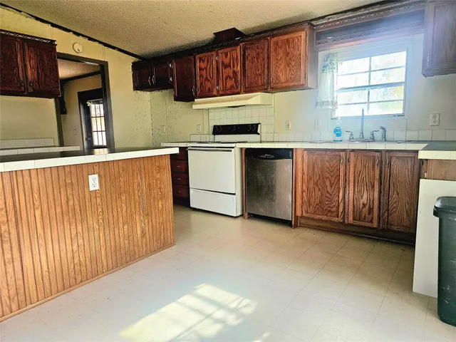 a kitchen with stainless steel appliances a refrigerator and a stove