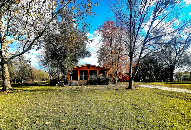 a front view of a building with trees