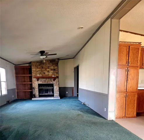 an empty room with furniture and a fireplace