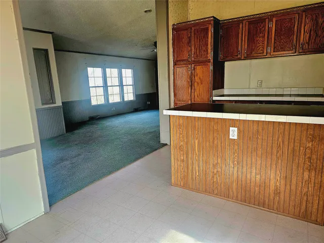 a view of cabinets and window in a room