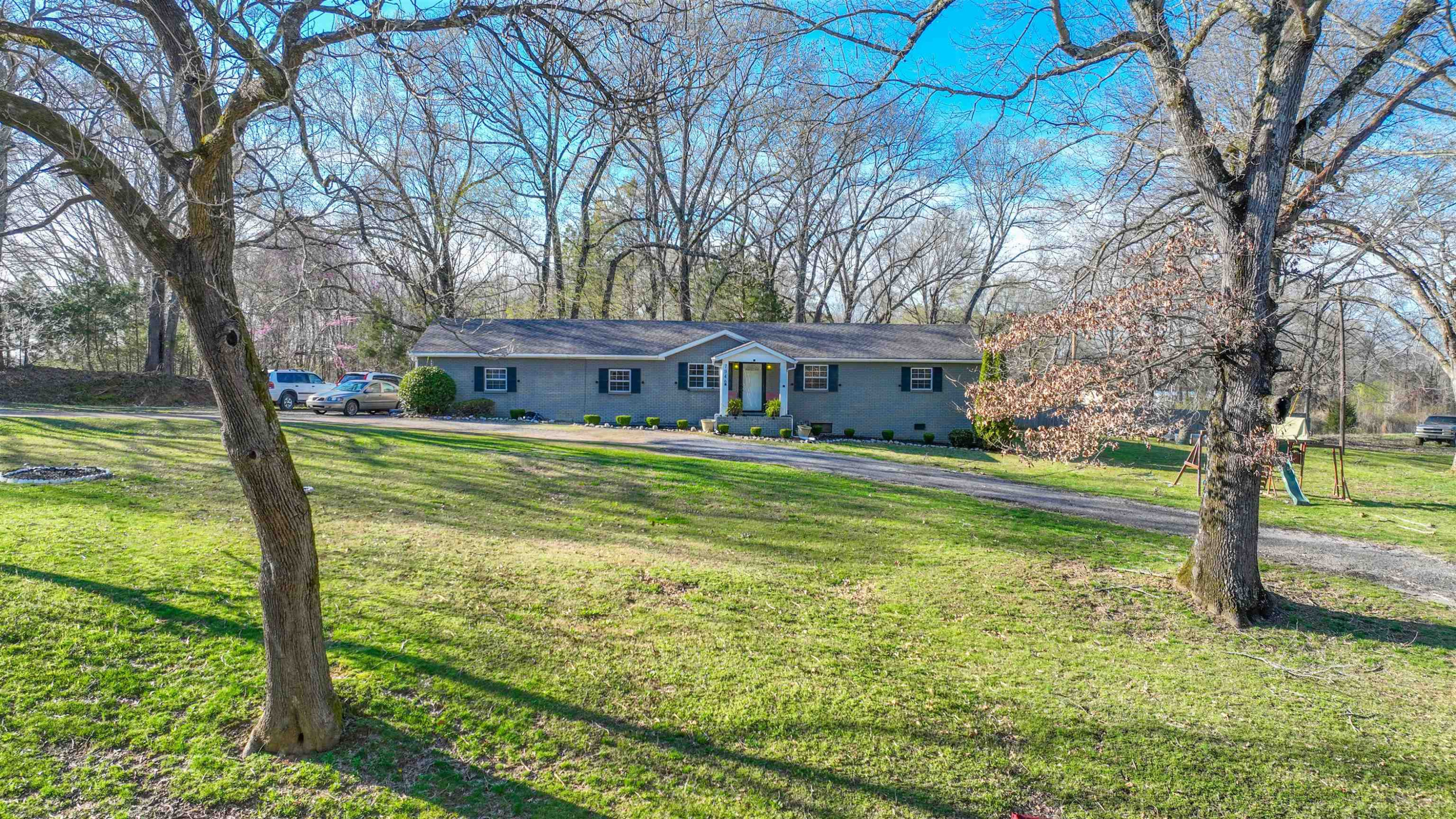 7946 Stanton Koko Road Stanton, TN 38069 - Photo 17 of 18 a view of a house with a big yard and large trees