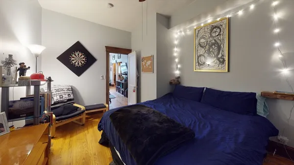 a bed room with a bed and a night stand