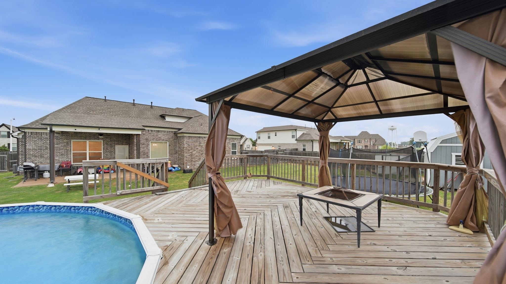 70 Trinity Cove Atoka, TN 38004 - Photo 25 of 25 Expansive wooden deck featuring an above-ground pool and a built-in gazebo