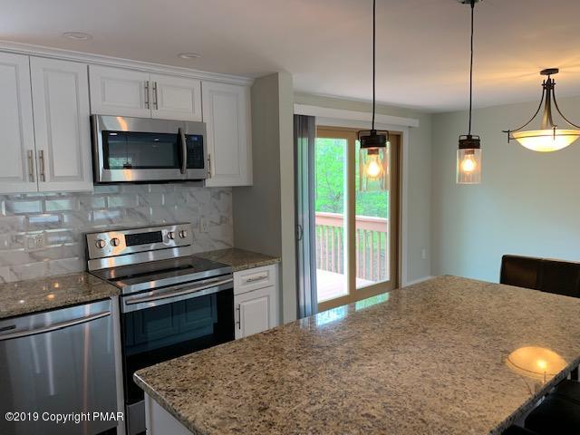 1023 Dancing Ridge Road East Stroudsburg, PA 18302 - Photo 8 of 23 a kitchen with stainless steel appliances granite countertop a stove a sink and a microwave