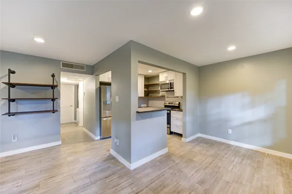 a view of a kitchen cabinets and wooden floor
