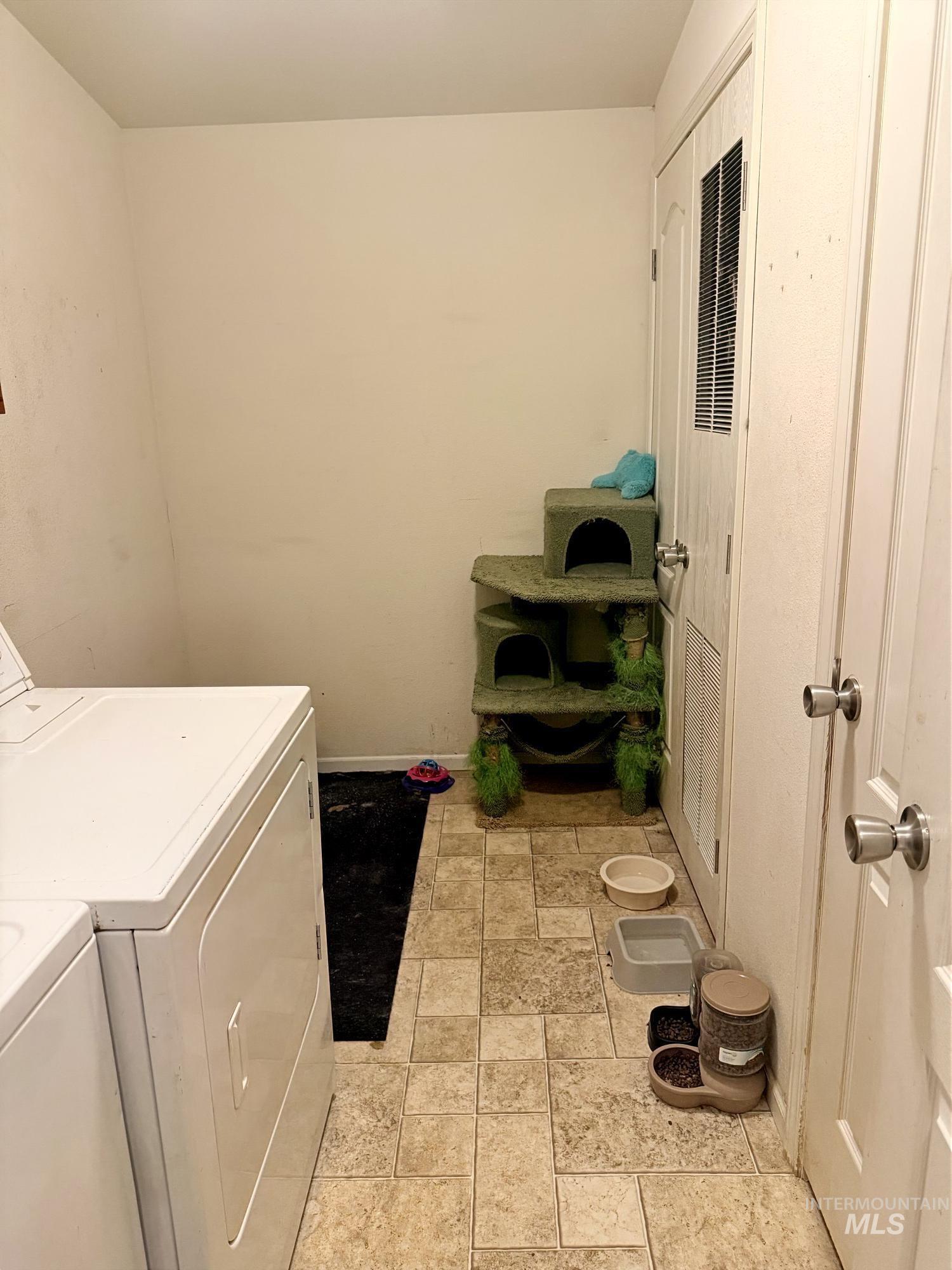 100 Ellsworth Street Vale, OR 97918 - Photo 23 of 25 Utility area with neutral wall paint and light-toned square tile flooring