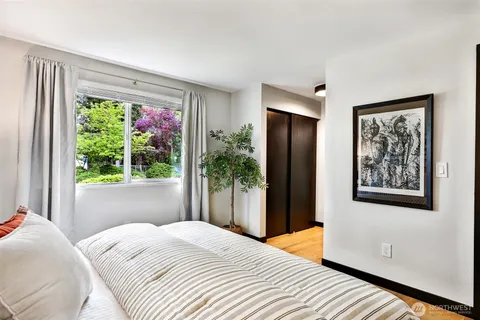 a bedroom with a bed and a large window