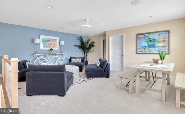 a living room with furniture and a painting on the wall
