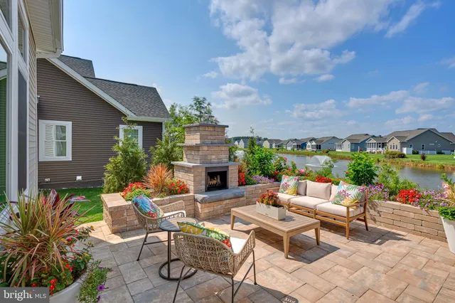 a view of a patio with couches and table and chairs and potted plants