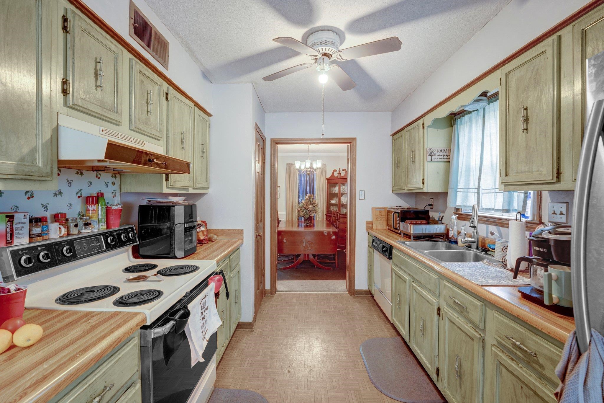 3086 Altruria Road Bartlett, TN 38134 - Photo 6 of 21 a kitchen with kitchen island a stove a sink and a refrigerator