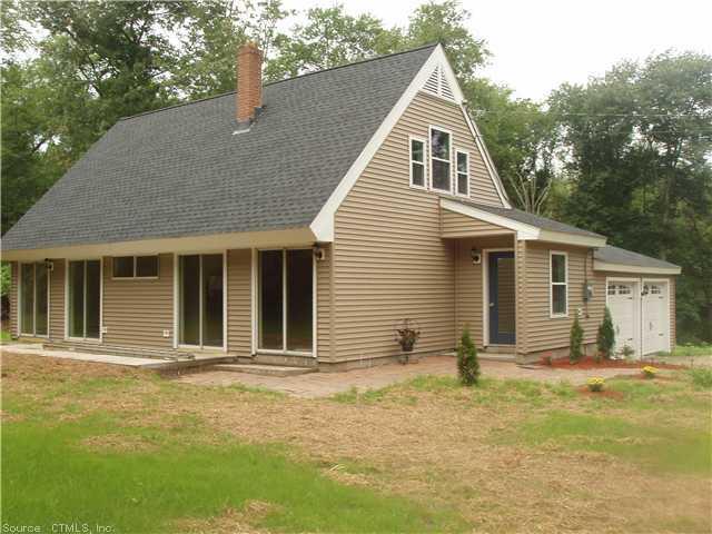 a view of a house with a backyard