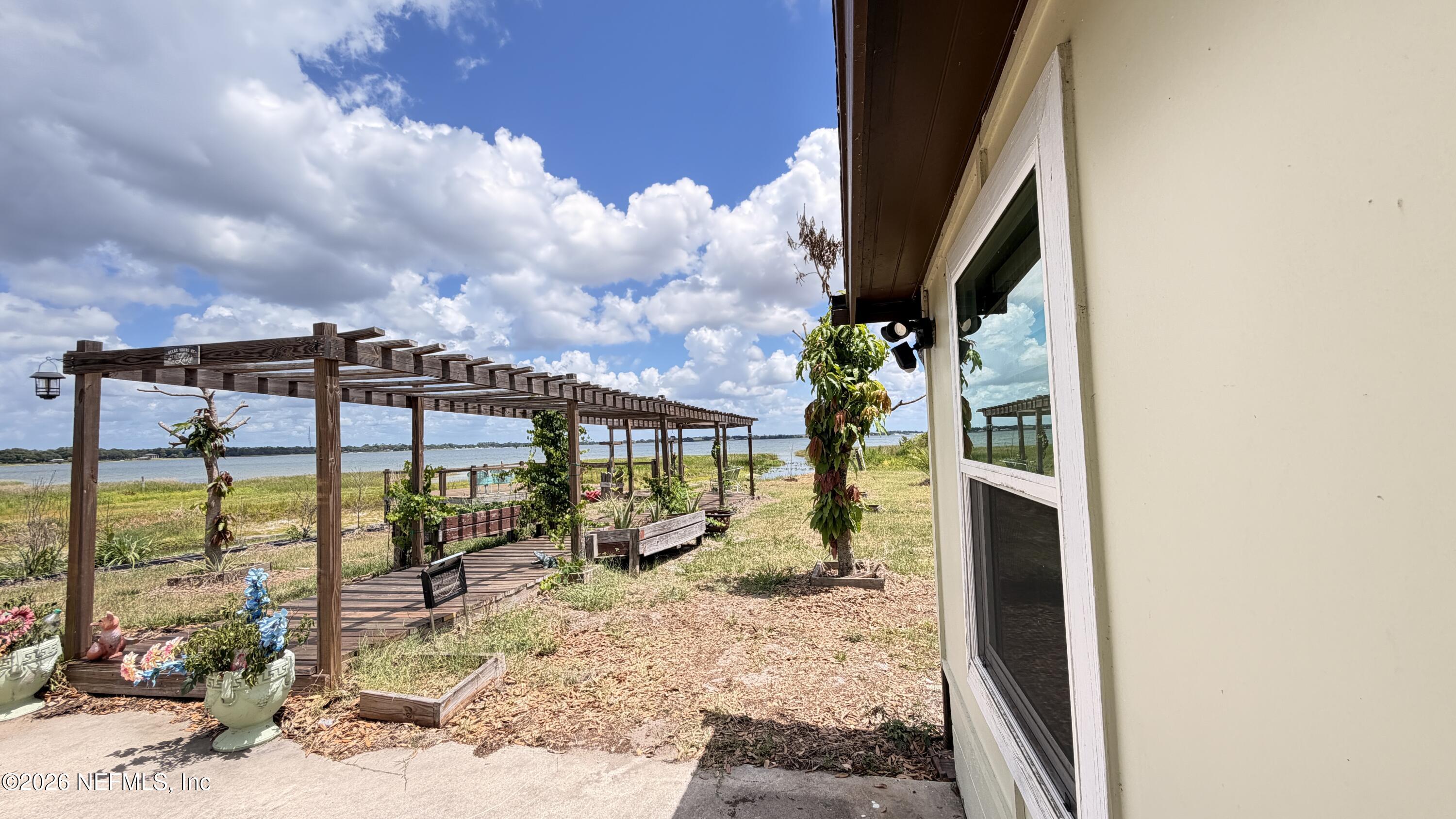 1302 Fort Meade Road Frostproof, FL 33843 - Photo 15 of 39 a view of a balcony with floor to ceiling windows yard