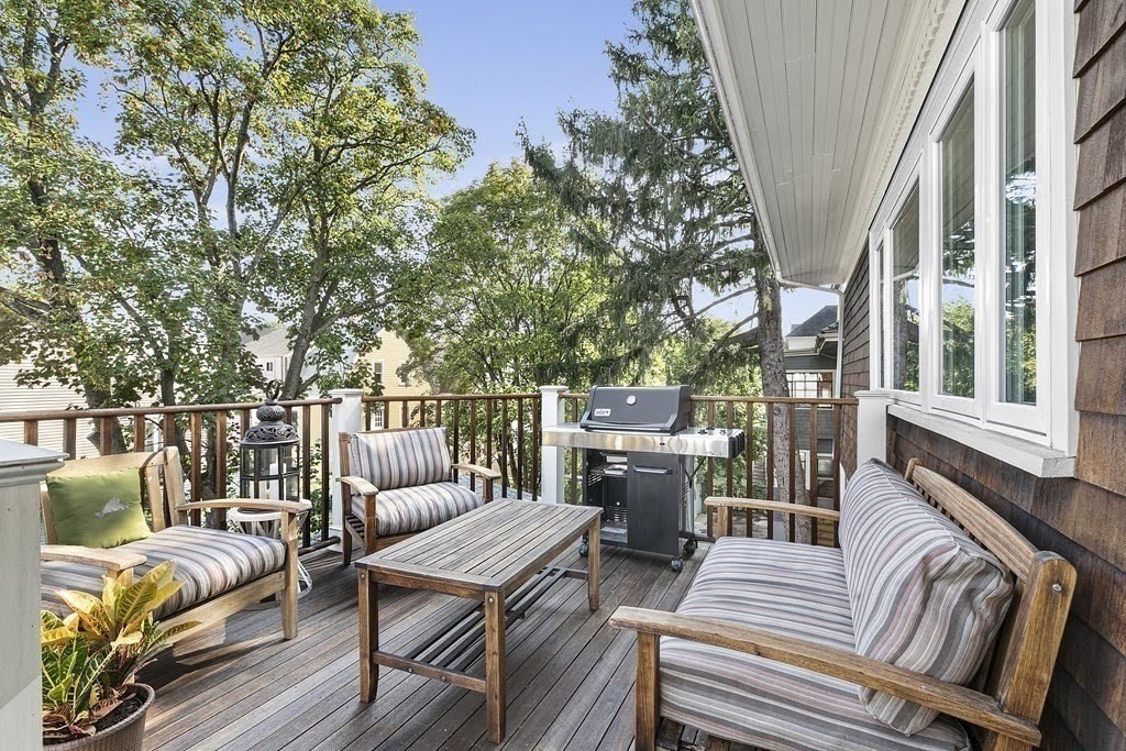 58 Liberty Avenue, Unit 2 Somerville, MA 02144 - Photo 11 of 22 a roof deck with couches and wooden fence