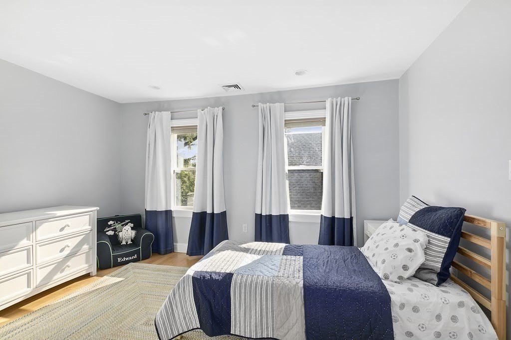 58 Liberty Avenue, Unit 2 Somerville, MA 02144 - Photo 15 of 22 a bedroom with a bed and a window