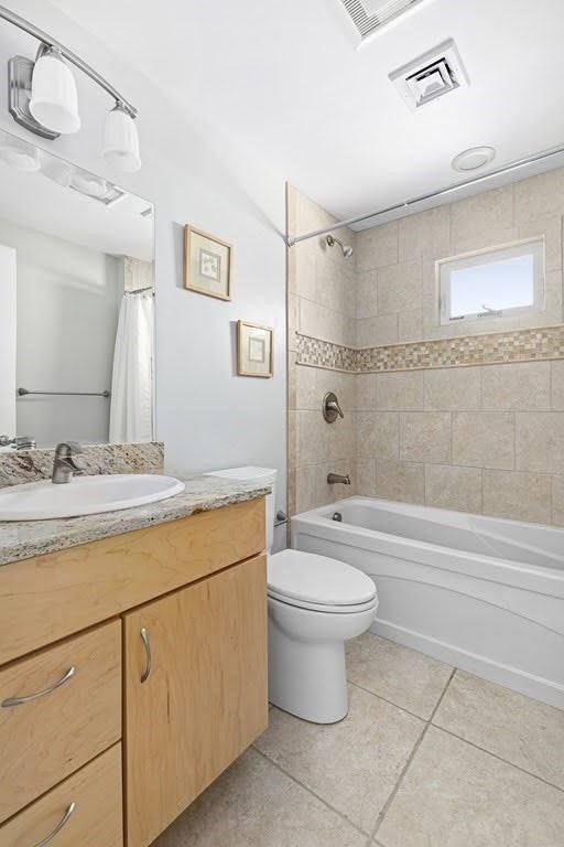 58 Liberty Avenue, Unit 2 Somerville, MA 02144 - Photo 17 of 22 a bathroom with a granite countertop toilet a sink and a bathtub