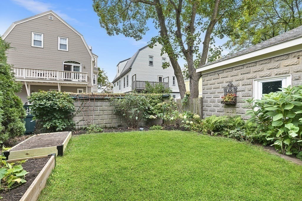 58 Liberty Avenue, Unit 2 Somerville, MA 02144 - Photo 20 of 22 a front view of a house with a yard and a garage